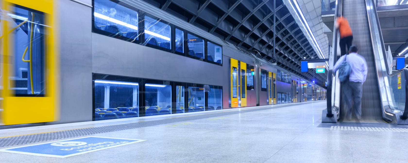 A train whizzes past a quiet train station platform