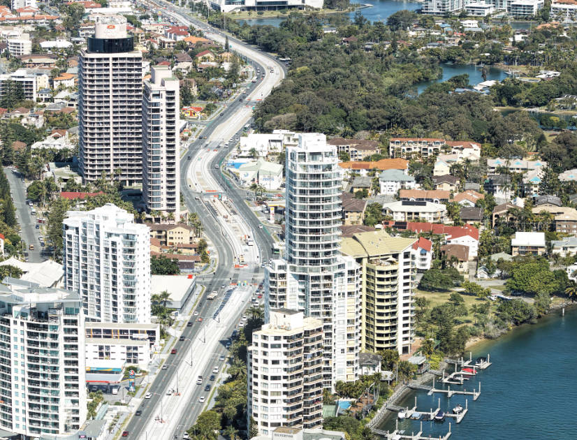 A light rail track zigzags through apartment towers