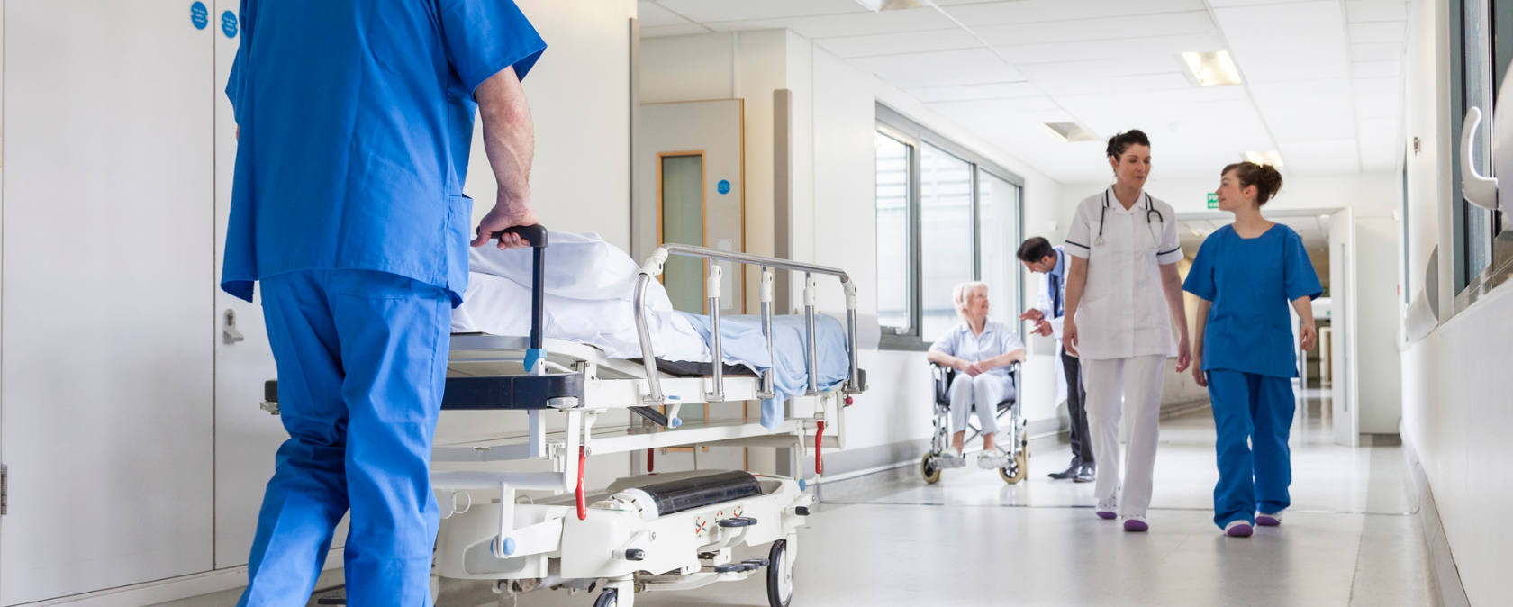 Medical staff walking through a hospital corridor