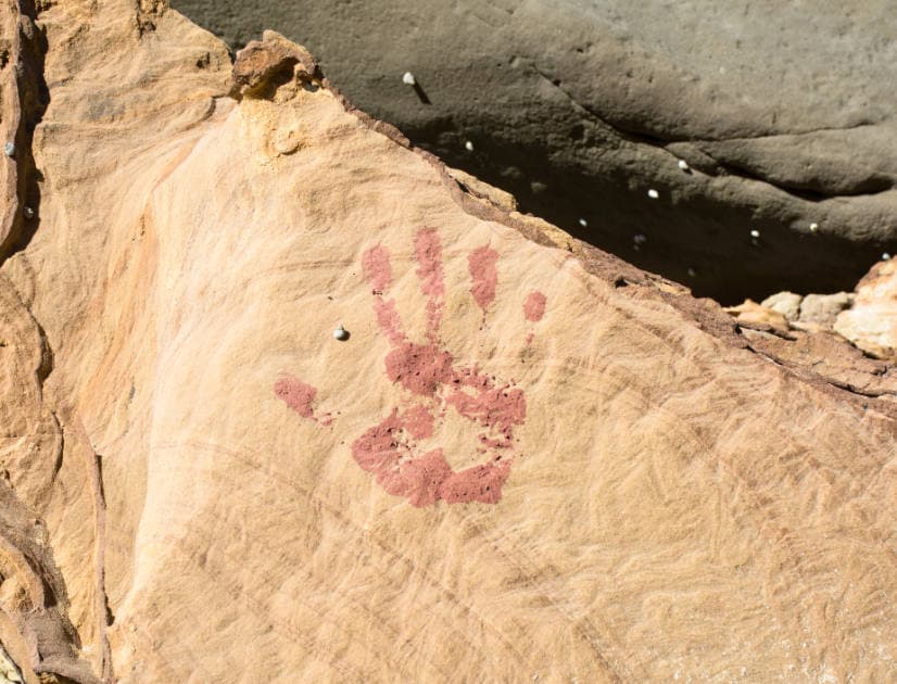 Red right handprint on ancient rock