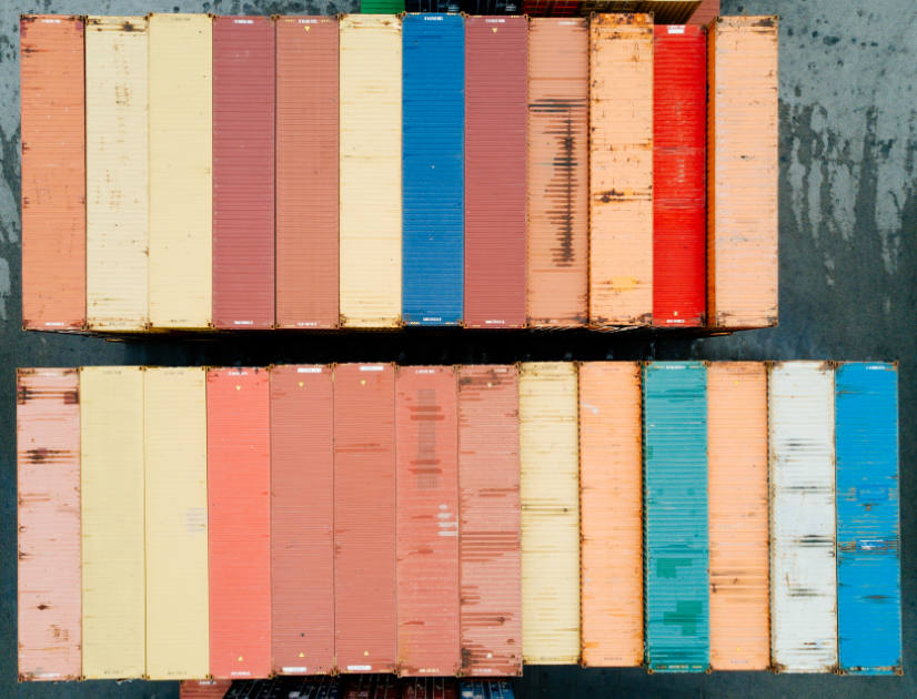 Rows of colourful shipping containers over the water